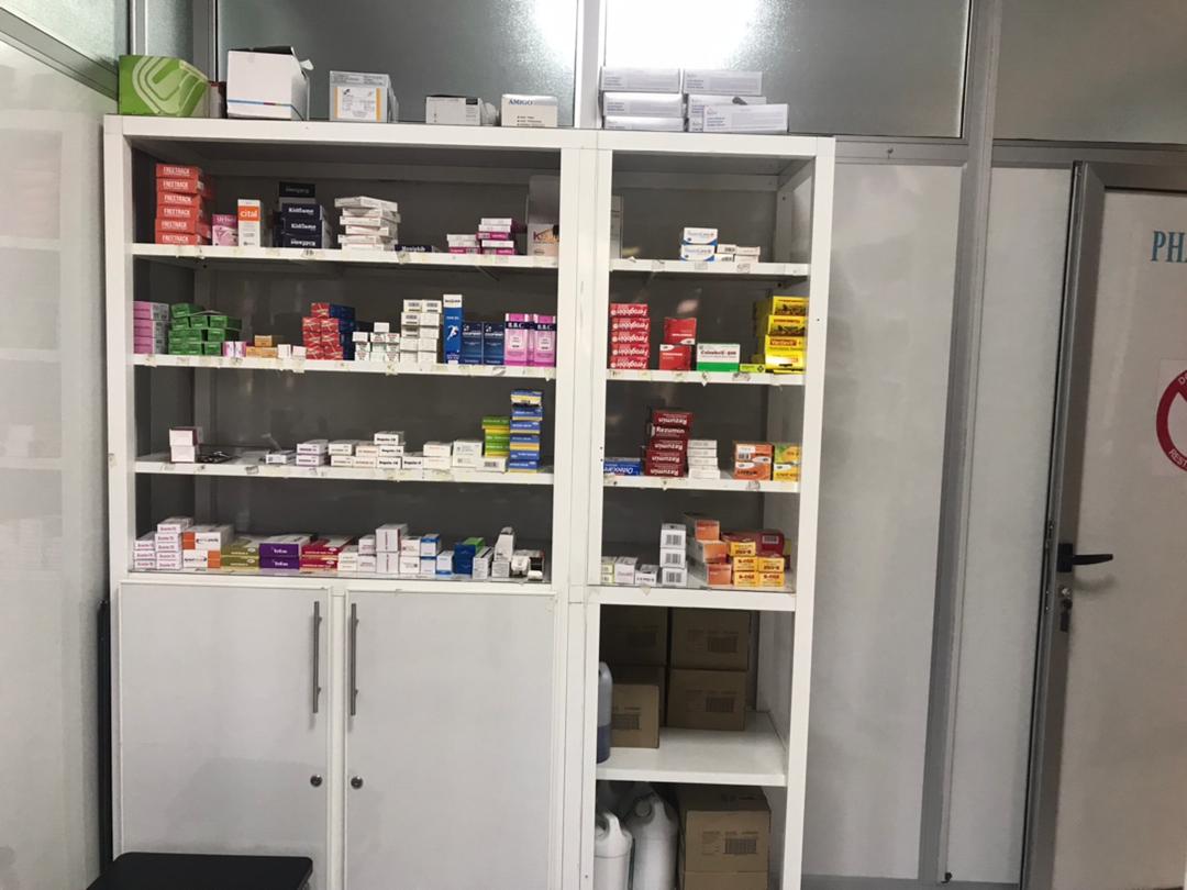 Well-stocked pharmacy shelves with prescription medications at Pharco Life Medical Centre